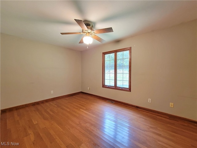 spare room featuring light wood-type flooring and ceiling fan