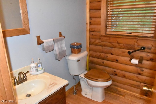 bathroom with vanity, toilet, and hardwood / wood-style flooring