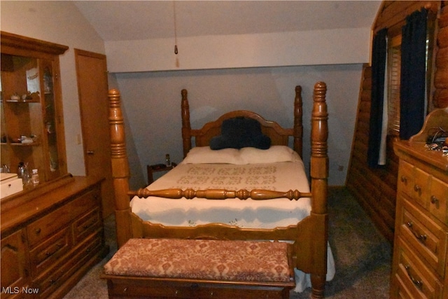 bedroom featuring vaulted ceiling and dark colored carpet