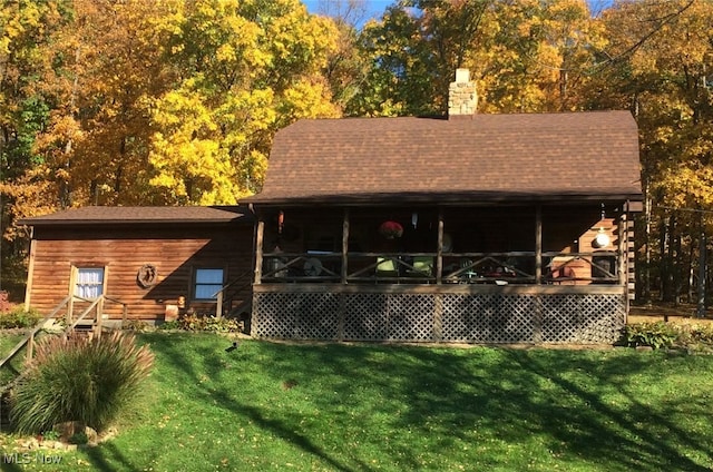 rear view of property with a yard