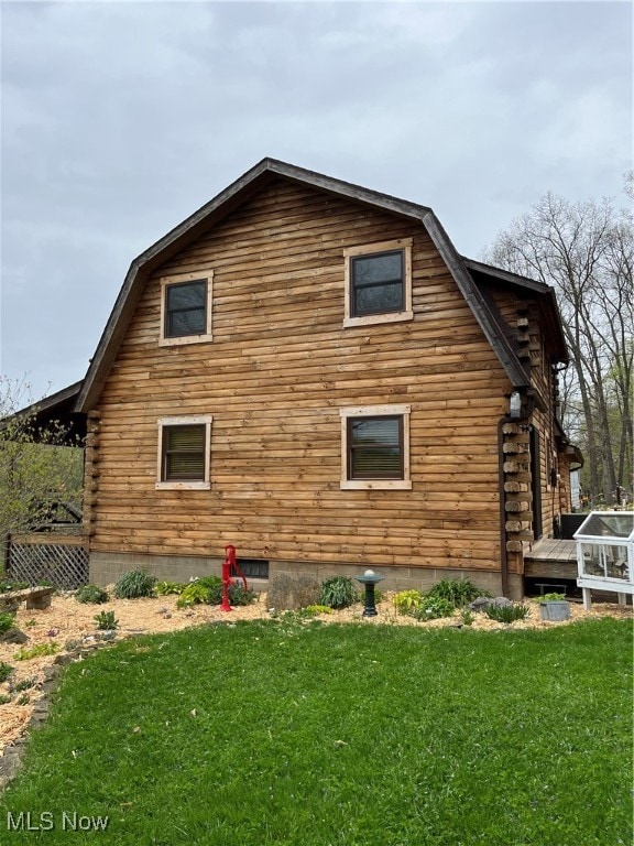 view of home's exterior featuring a yard and a deck