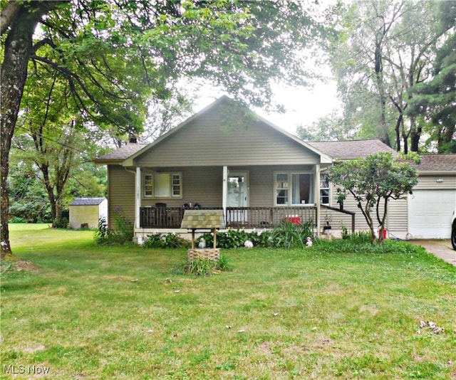 view of front of house with a front yard, a garage, and a porch