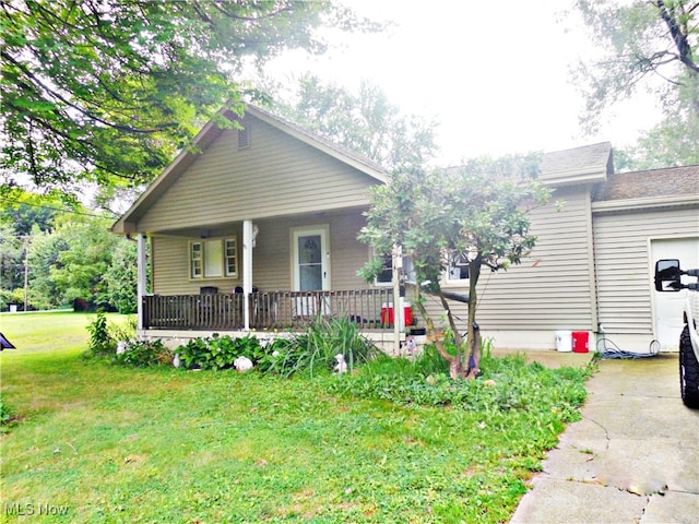 bungalow-style home with a front yard and covered porch