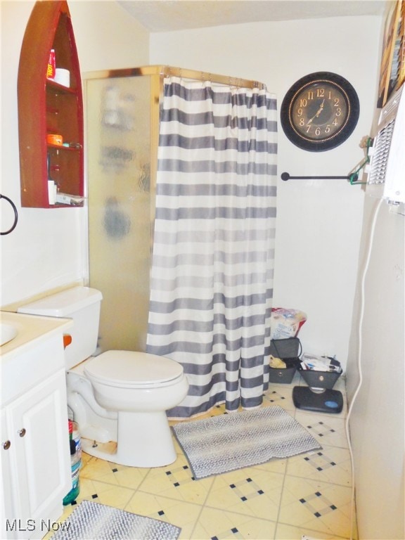 bathroom with tile patterned flooring, vanity, toilet, and a shower with curtain