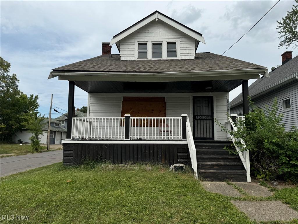 12001 Dove Ave, Cleveland, OH 44105 - bungalow-style home with a front yard and covered porch