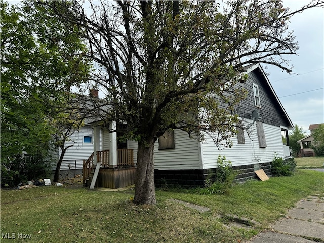 view of side of home featuring a lawn