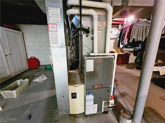 utility room featuring heating unit