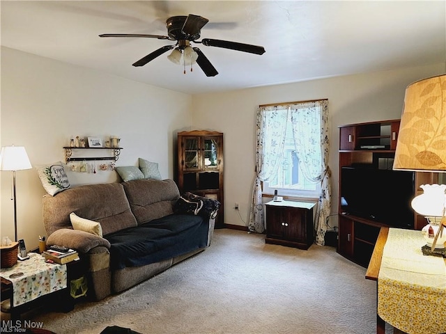 carpeted living room featuring ceiling fan