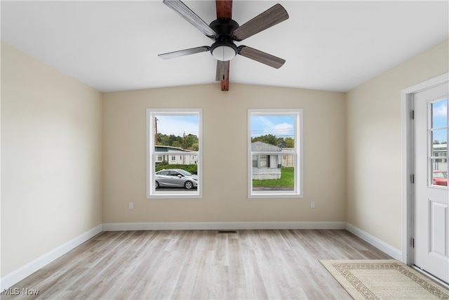 unfurnished room with ceiling fan, vaulted ceiling with beams, and light hardwood / wood-style flooring