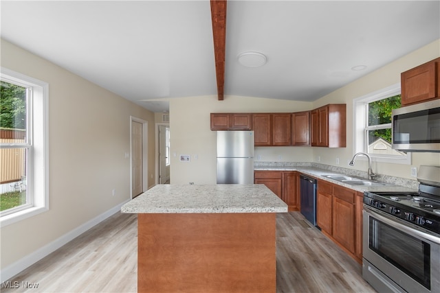 kitchen with light hardwood / wood-style floors, a center island, stainless steel appliances, and plenty of natural light