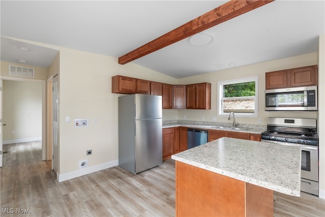 kitchen with appliances with stainless steel finishes, light hardwood / wood-style floors, a center island, vaulted ceiling with beams, and sink