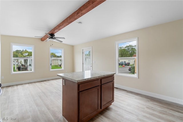 kitchen with light wood-type flooring, ceiling fan, and a wealth of natural light