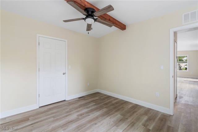 spare room with light hardwood / wood-style flooring, beam ceiling, and ceiling fan