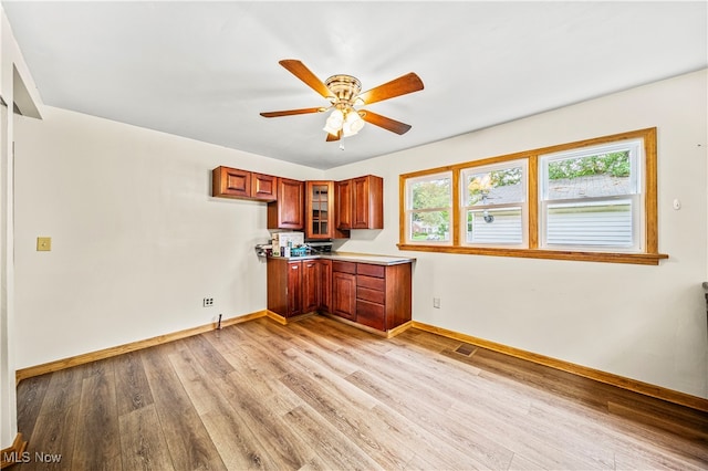 kitchen with light hardwood / wood-style flooring and ceiling fan