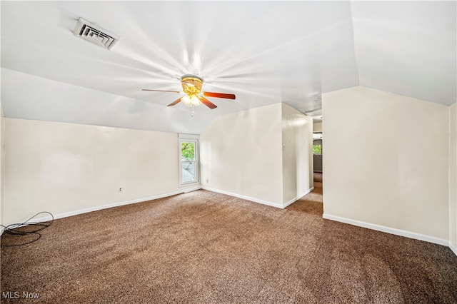 carpeted empty room featuring vaulted ceiling