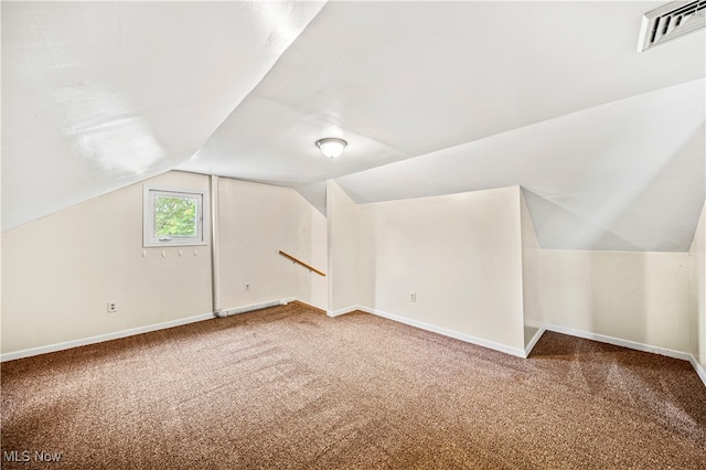 additional living space featuring lofted ceiling and carpet flooring