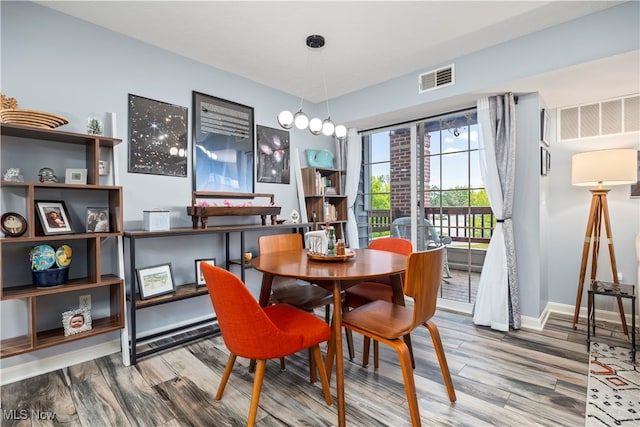 dining space with wood-type flooring