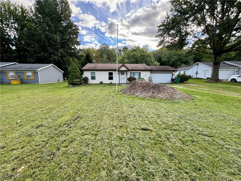 ranch-style house with a front lawn and a garage