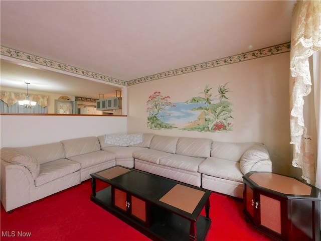 carpeted living room featuring a chandelier