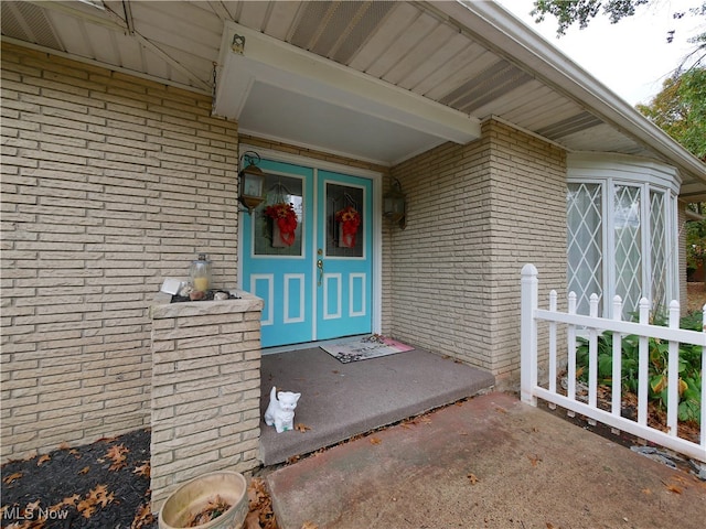 view of exterior entry with covered porch