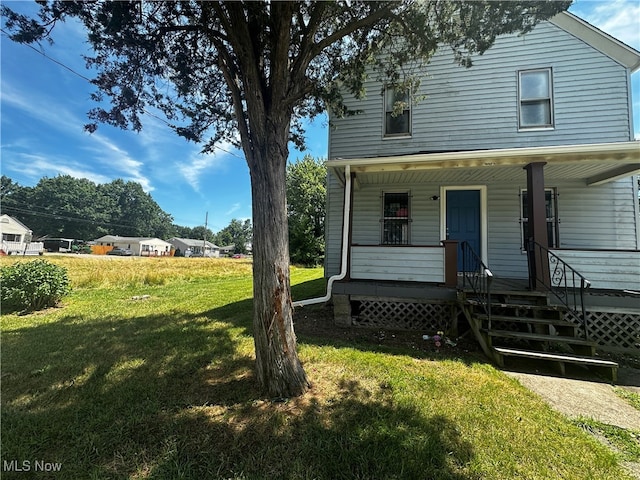 view of front of home featuring covered porch and a front yard