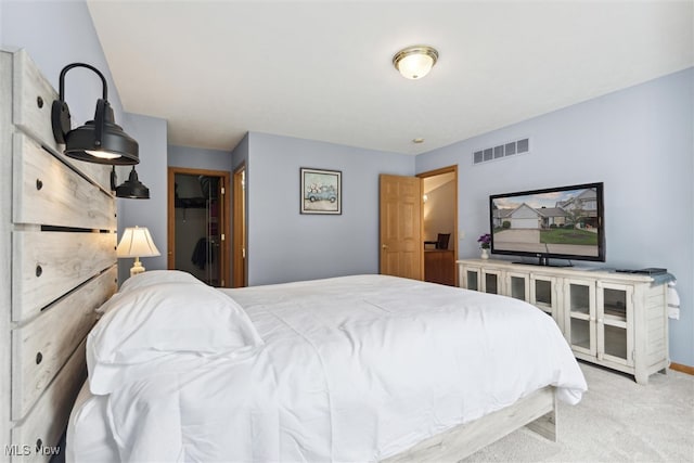 bedroom with light colored carpet and a closet