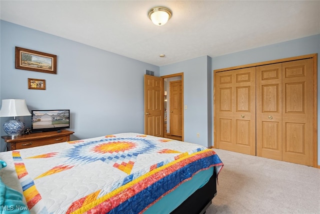 carpeted bedroom featuring a closet