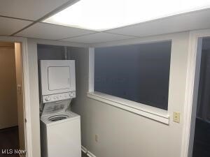 laundry room with stacked washer / drying machine