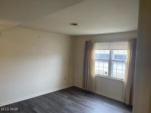 empty room featuring dark hardwood / wood-style flooring