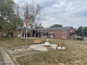 view of property's community with a patio and a yard