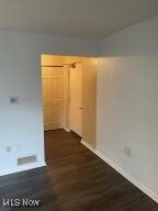 spare room with dark hardwood / wood-style flooring