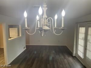 unfurnished dining area with dark hardwood / wood-style floors and vaulted ceiling