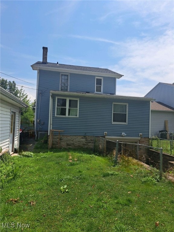 rear view of house with a lawn