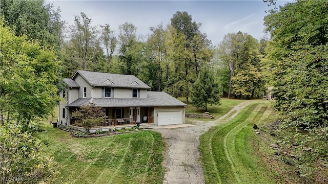 view of front of house featuring a front lawn, a garage, central AC, and covered porch