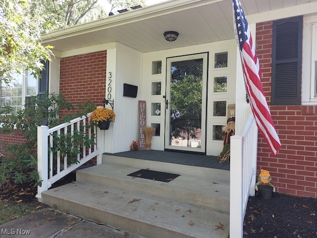 doorway to property featuring a porch