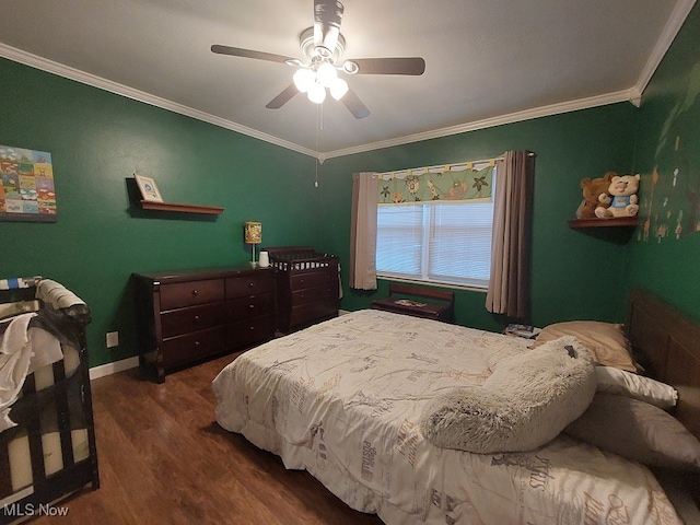 bedroom featuring ornamental molding, dark hardwood / wood-style flooring, and ceiling fan