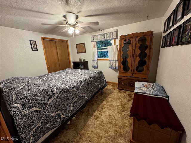 bedroom featuring a closet, dark colored carpet, ceiling fan, and a textured ceiling