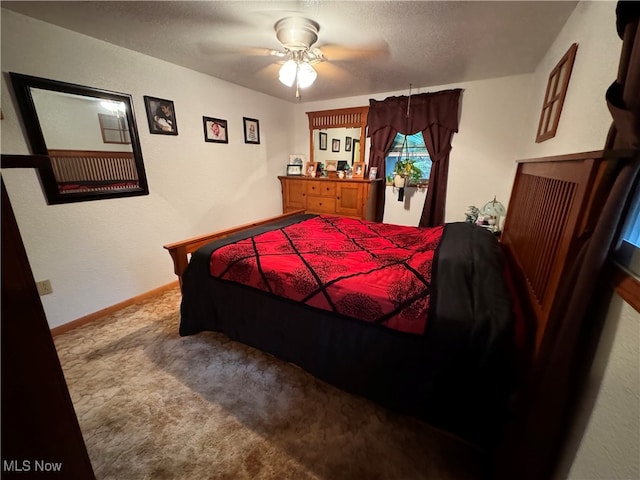 bedroom featuring ceiling fan, carpet floors, and a textured ceiling