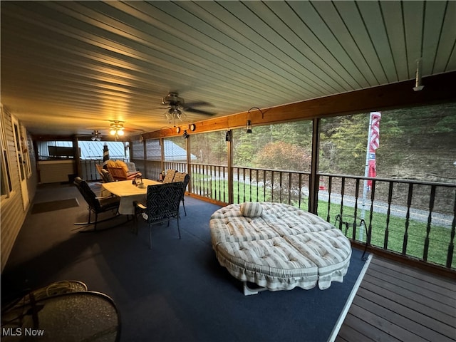 sunroom with a healthy amount of sunlight and ceiling fan