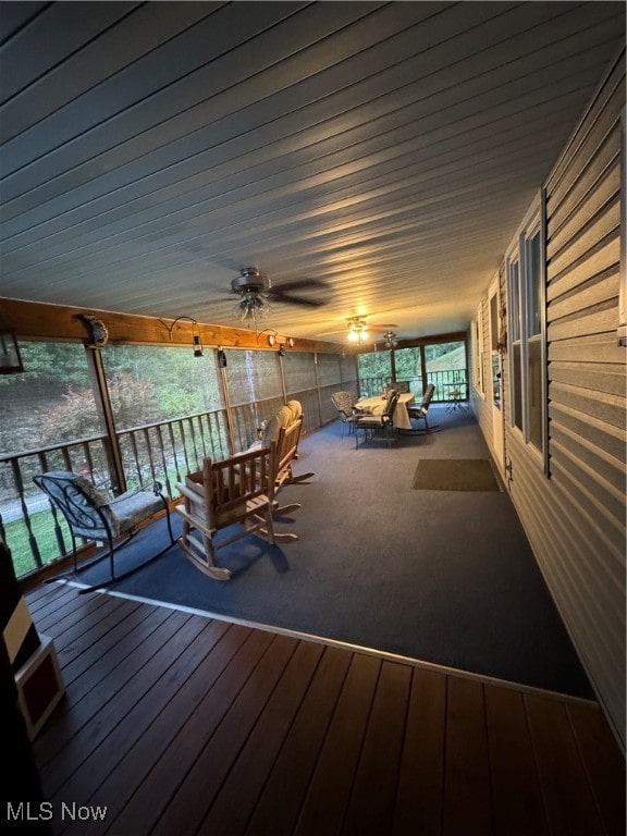 wooden terrace featuring an outdoor living space and ceiling fan