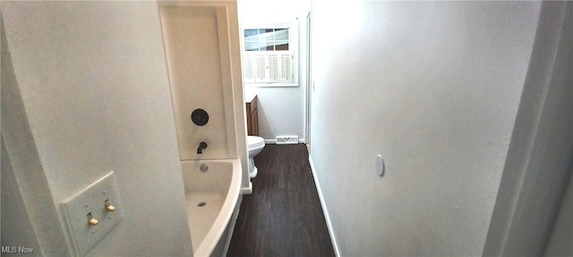 interior space with toilet, hardwood / wood-style floors, vanity, and shower with separate bathtub