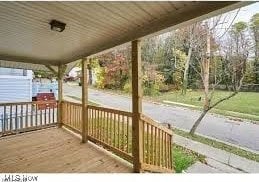 wooden terrace featuring covered porch