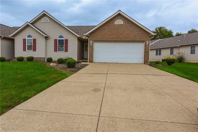 view of front of home with a front yard and a garage