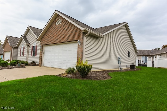 view of side of home featuring a lawn, central air condition unit, and a garage