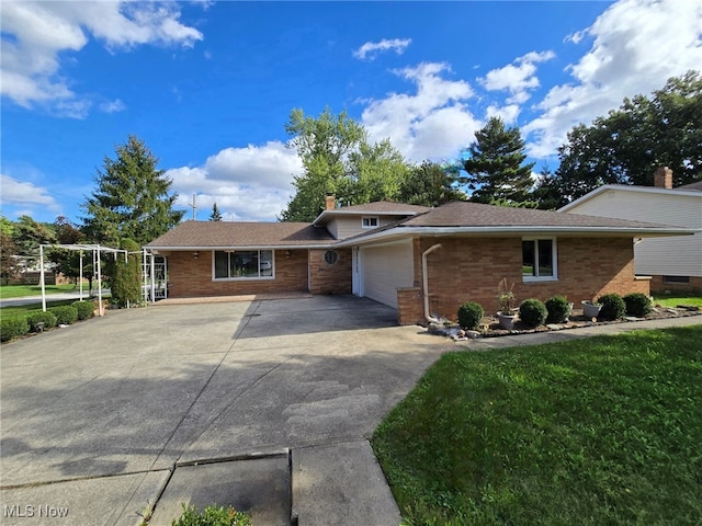 view of front of home with a garage and a front lawn