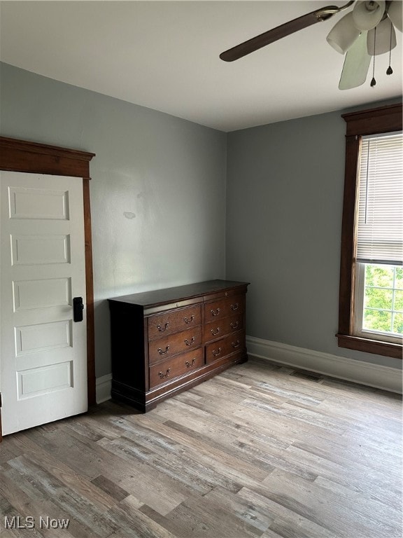 unfurnished room with light hardwood / wood-style flooring and ceiling fan