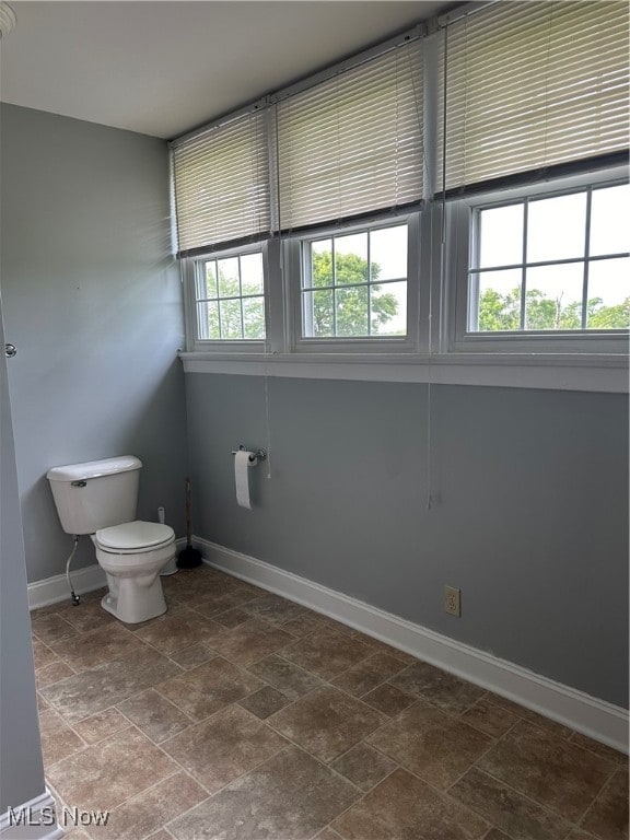 bathroom featuring a healthy amount of sunlight and toilet