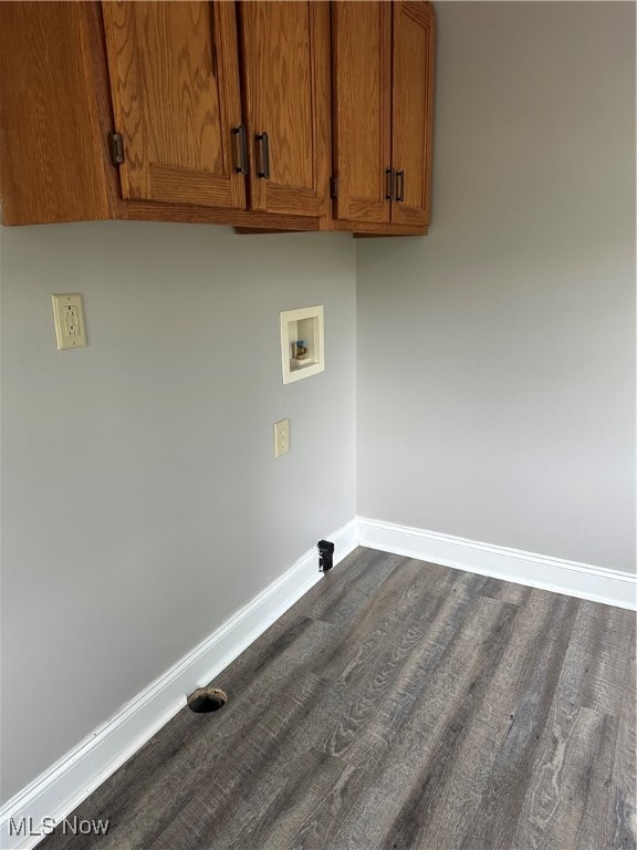 clothes washing area featuring cabinets, hookup for a washing machine, and dark wood-type flooring