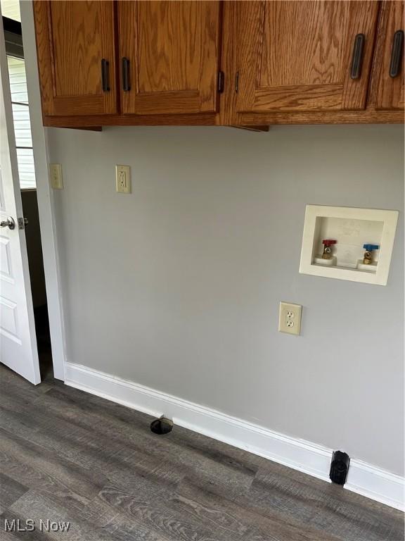 laundry area featuring washer hookup, baseboards, cabinet space, and dark wood-style flooring