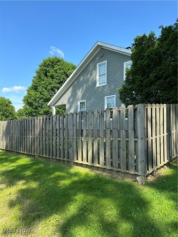 view of side of property with a lawn